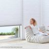 woman enjoying cool room with energy efficient shades